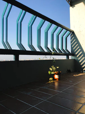 A compact balcony solar panel kit neatly installed on a small urban balcony with sunlight filtering through.