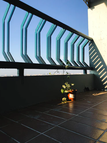 A compact balcony solar panel kit neatly installed on a small urban balcony with sunlight streaming in.