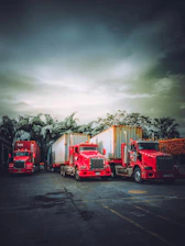 A lineup of Logancrest trucks parked under a moody sky, ready for the next haul.