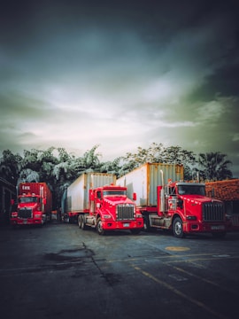 A fleet of red trucks lined up ready for dispatch.