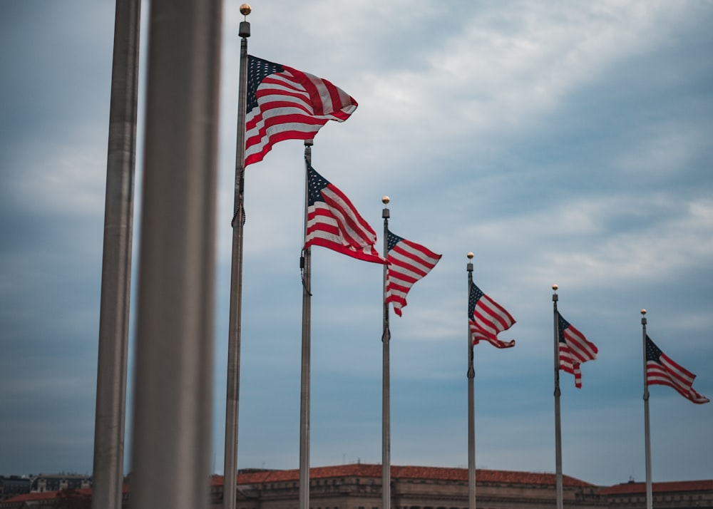 a group of american flags flying in the wind