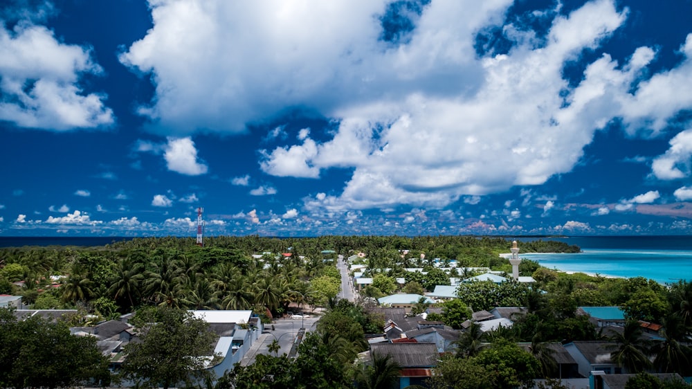 white and brown houses under blue and white cloudy sky during daytime