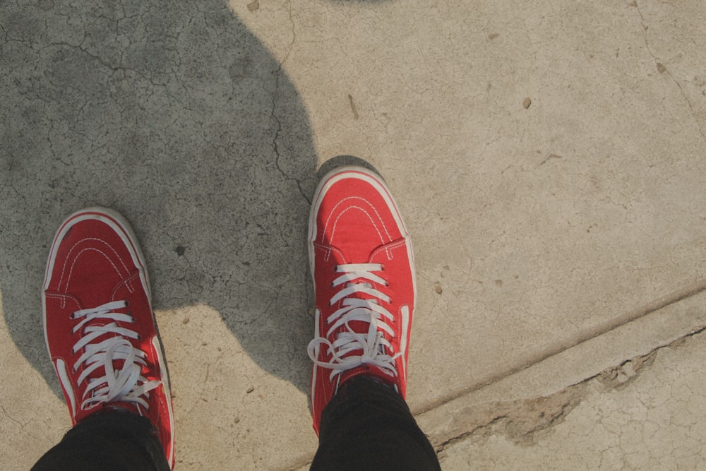 person in red and white nike sneakers