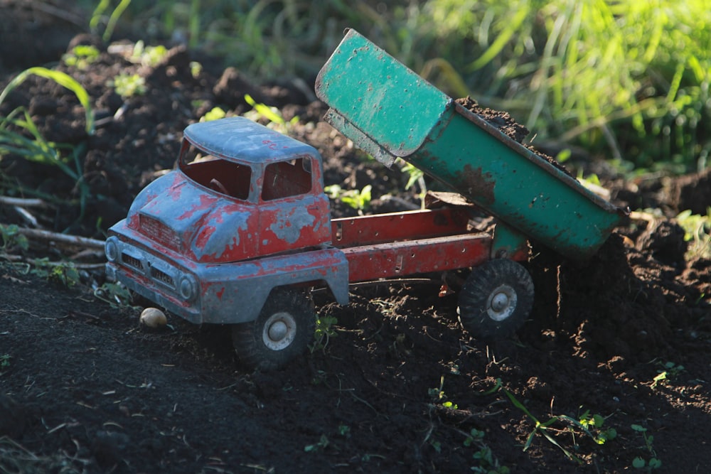 red and black ride on toy car on green grass during daytime