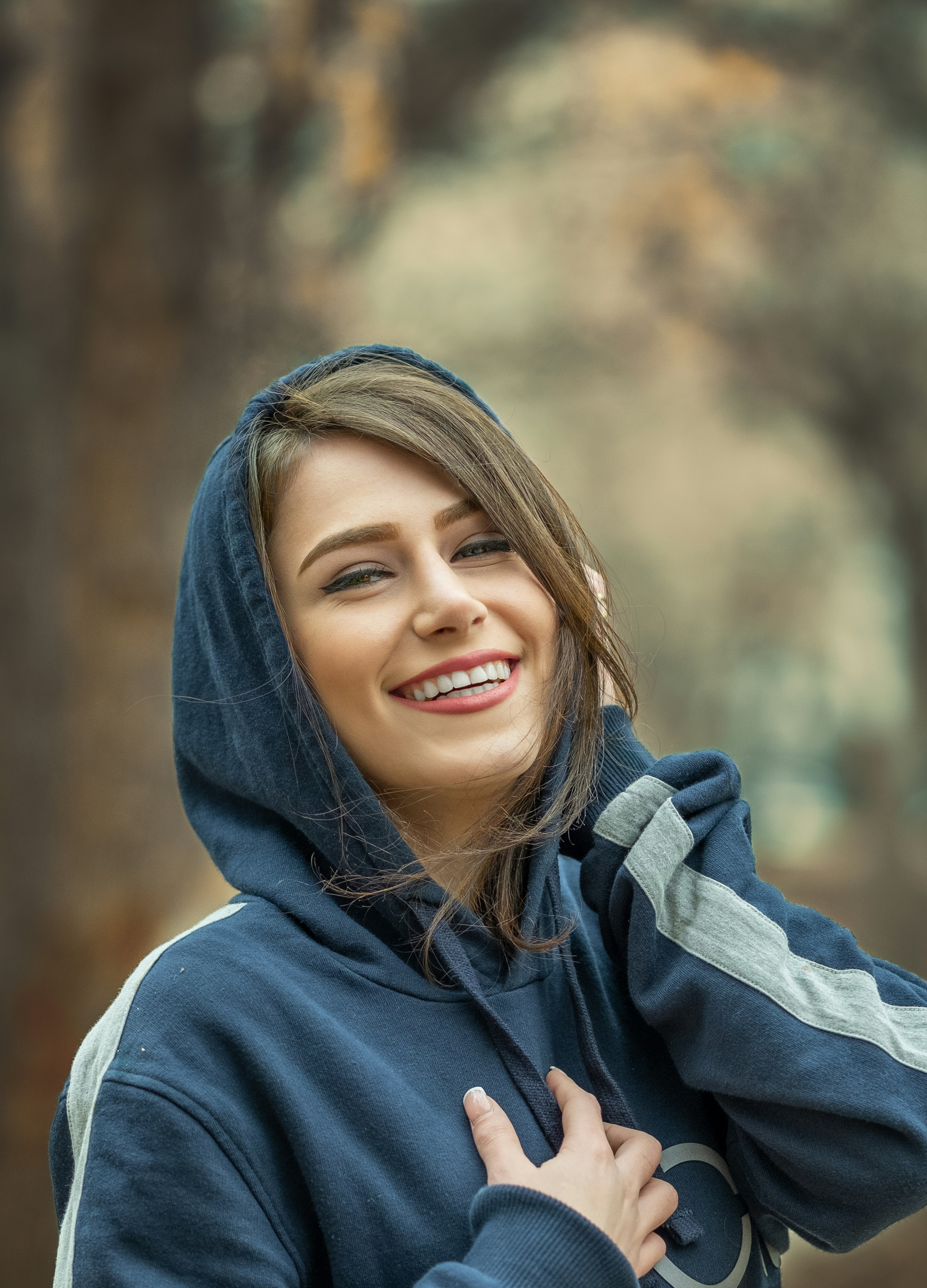 smiling woman in gray hoodie