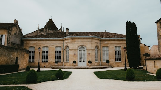 beige concrete building under white sky during daytime in Saint-Émilion France