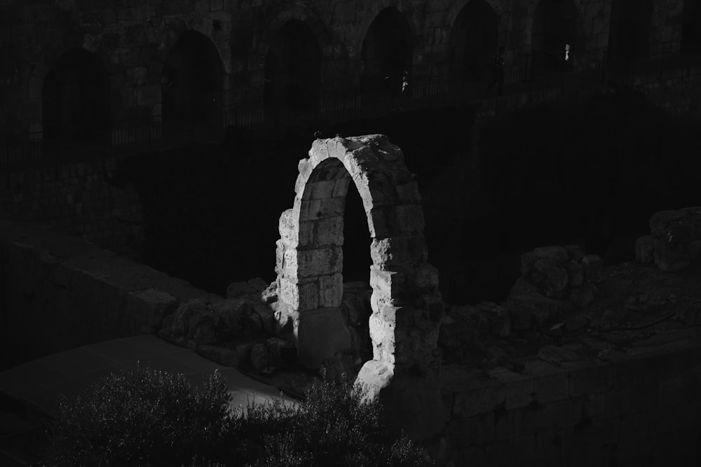 grayscale photo of brick arch