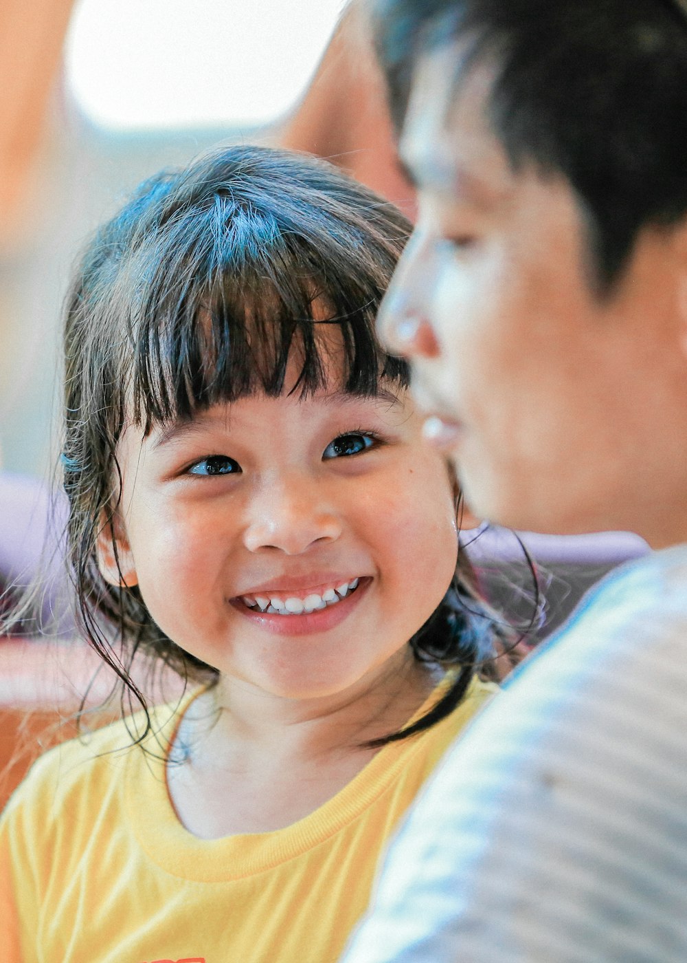 smiling girl in yellow shirt