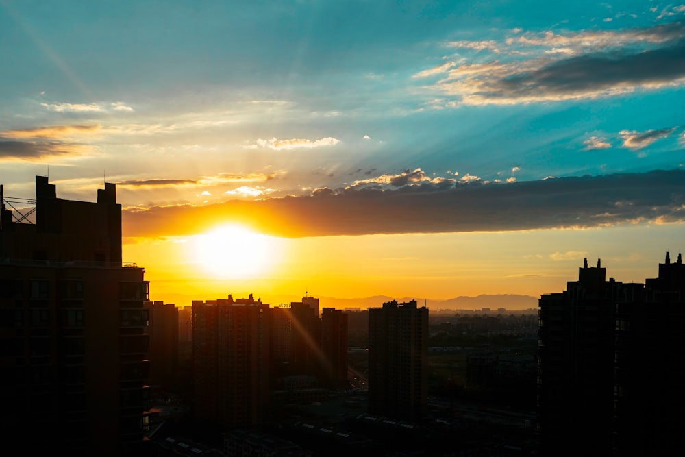 silhouette of city buildings during sunset