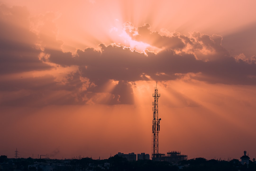 silhouette of tower under blue sky during daytime