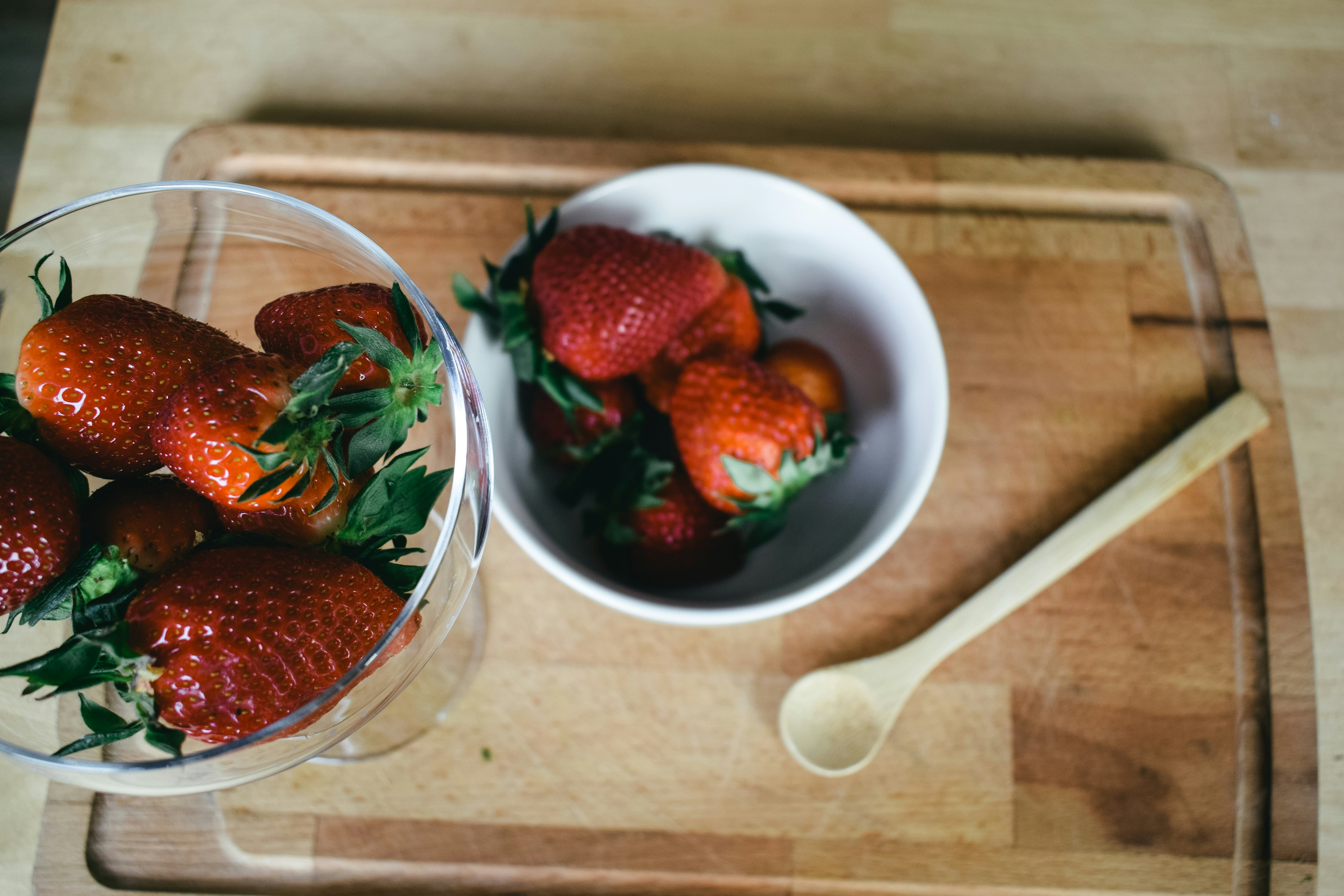 strawberries in clear glass bowl