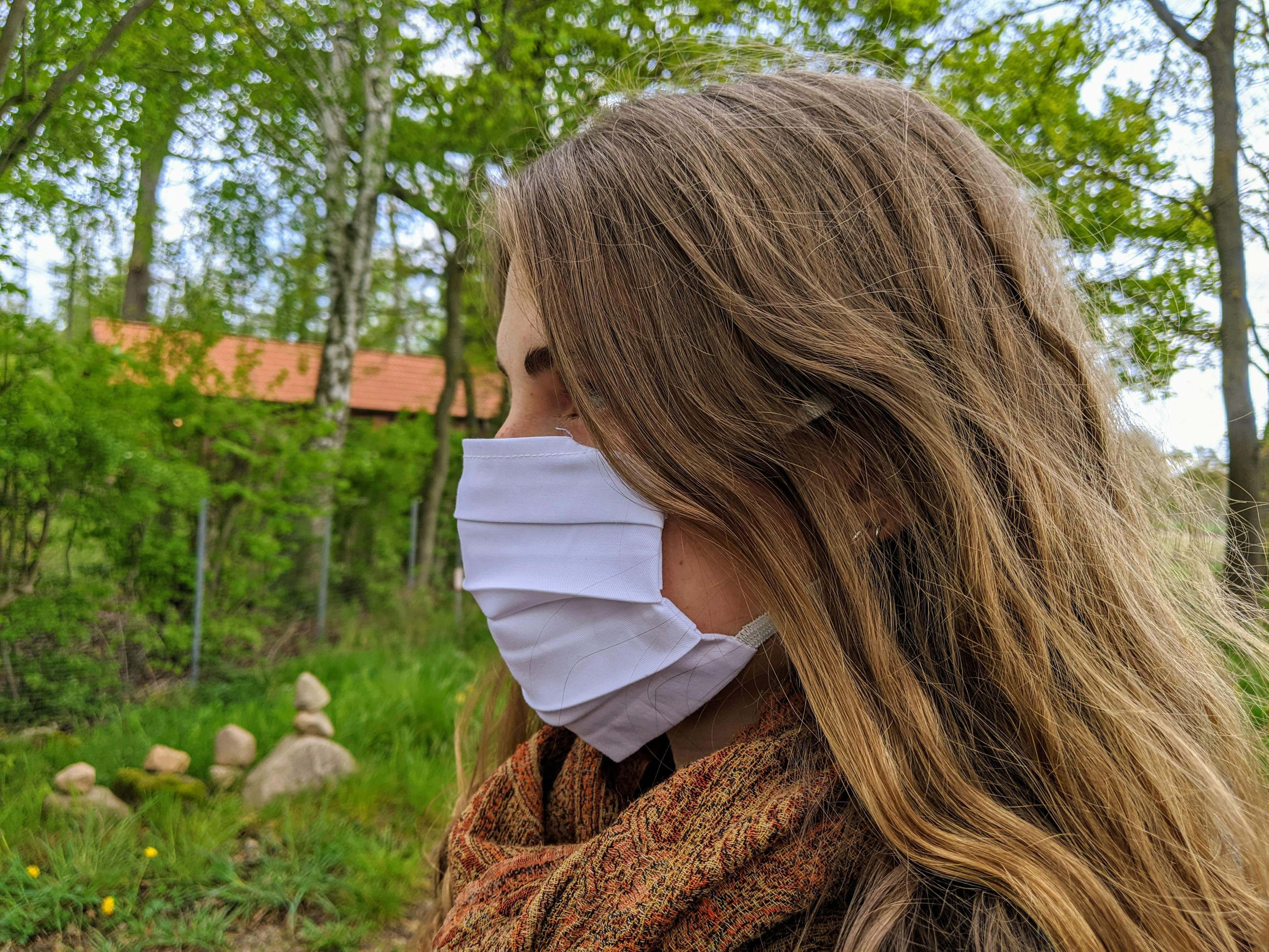 Woman wearing a white face mask; How IV Hydration Saves Your Allergy Season