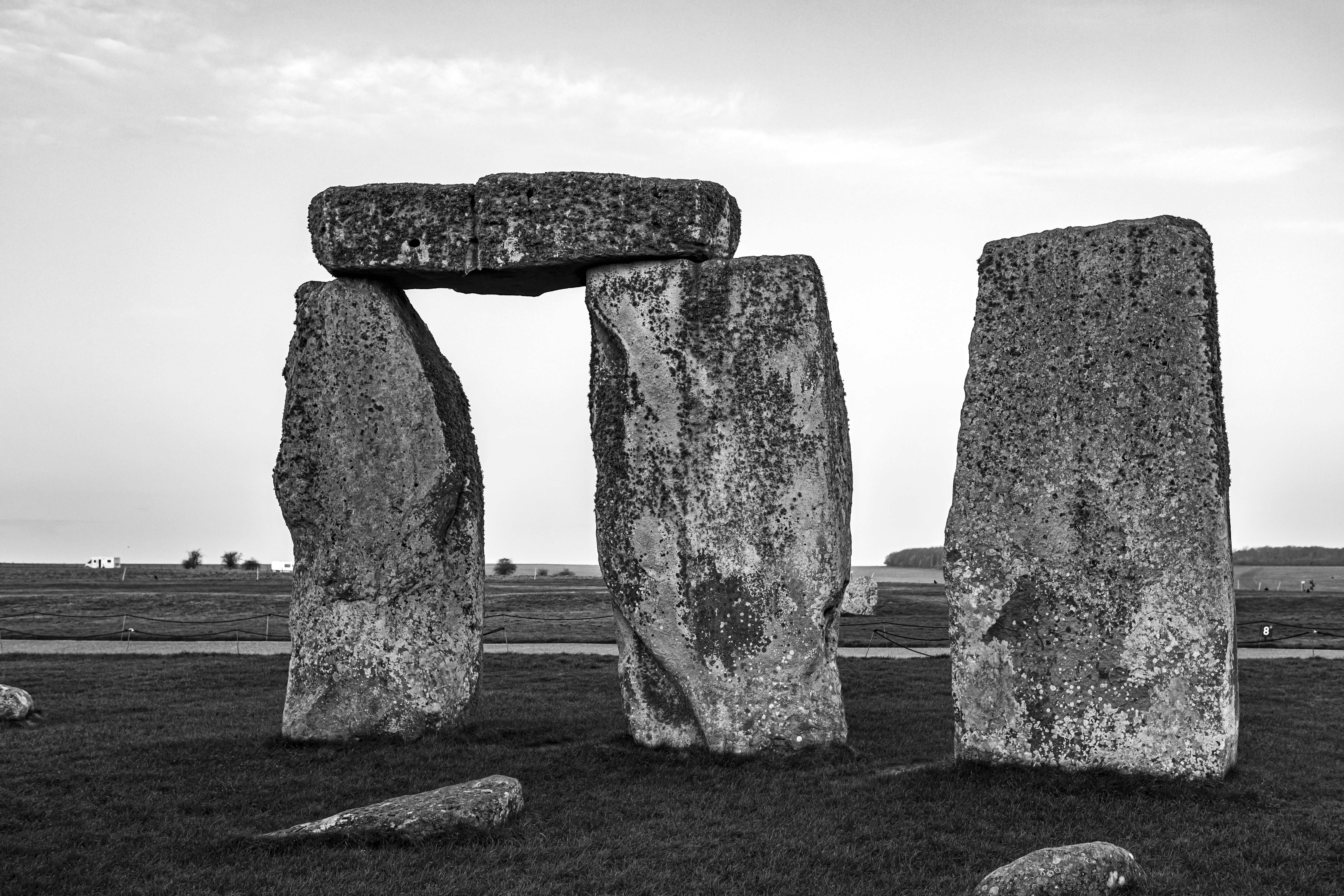gray rock formation under white clouds during daytime, Prehistoric ritual site of Stonehenge with monliths - large stone slabs in rural England, UK. February 2020. Sunrise time.