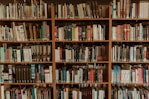 brown wooden book shelf with books