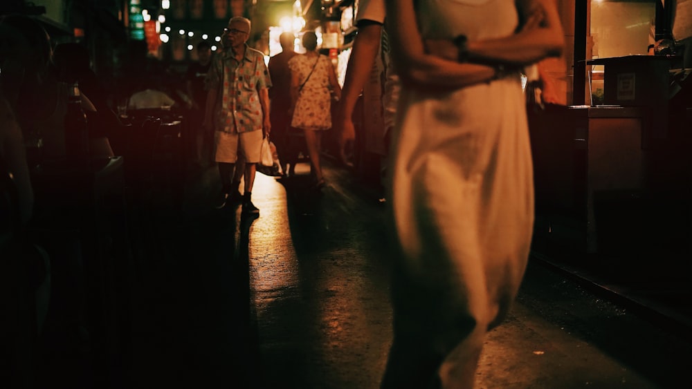 people walking on street during night time