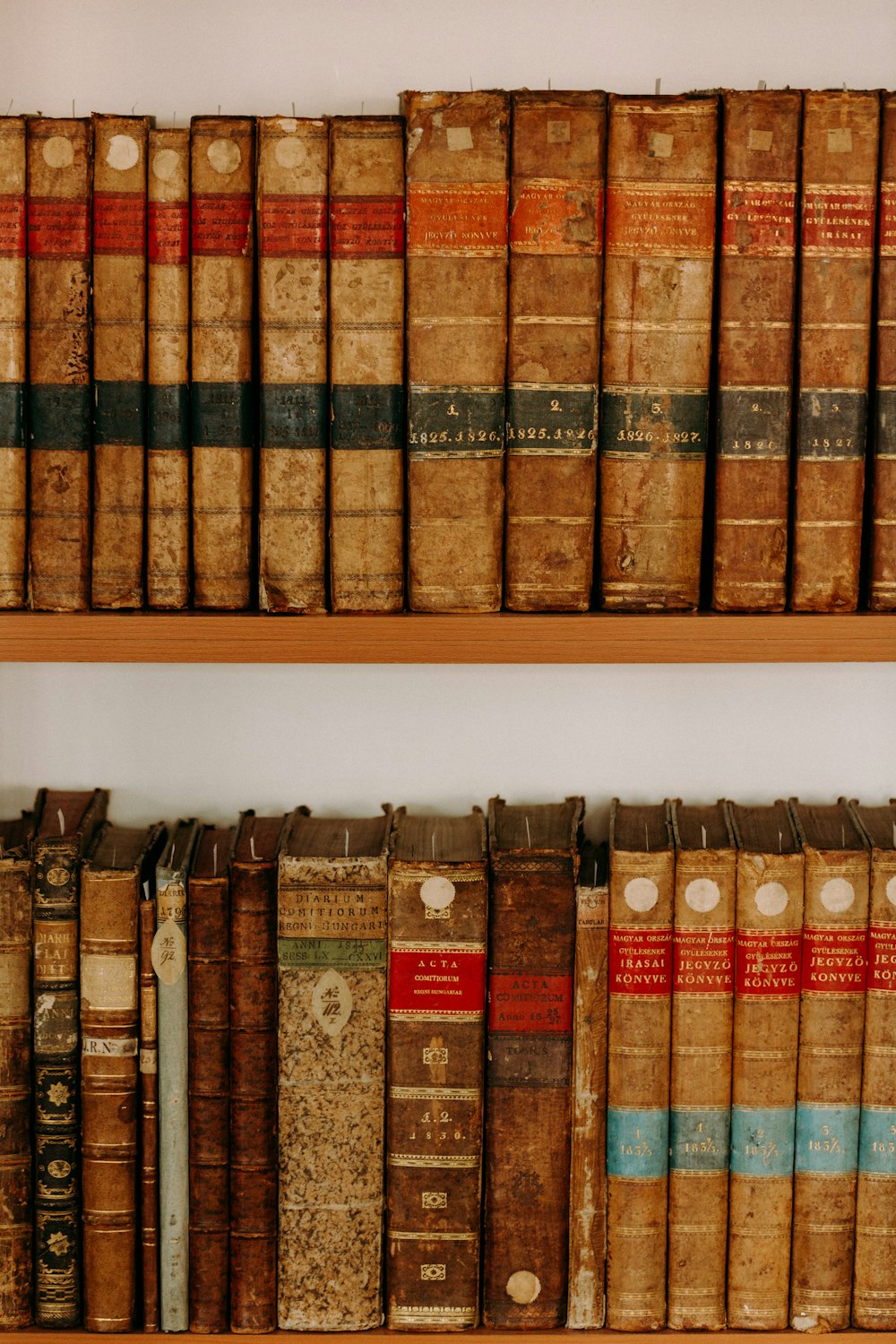 books on white wooden shelf