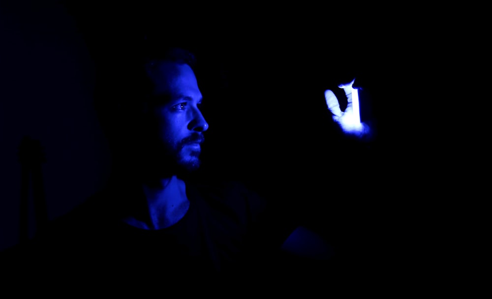 man in black shirt with blue light