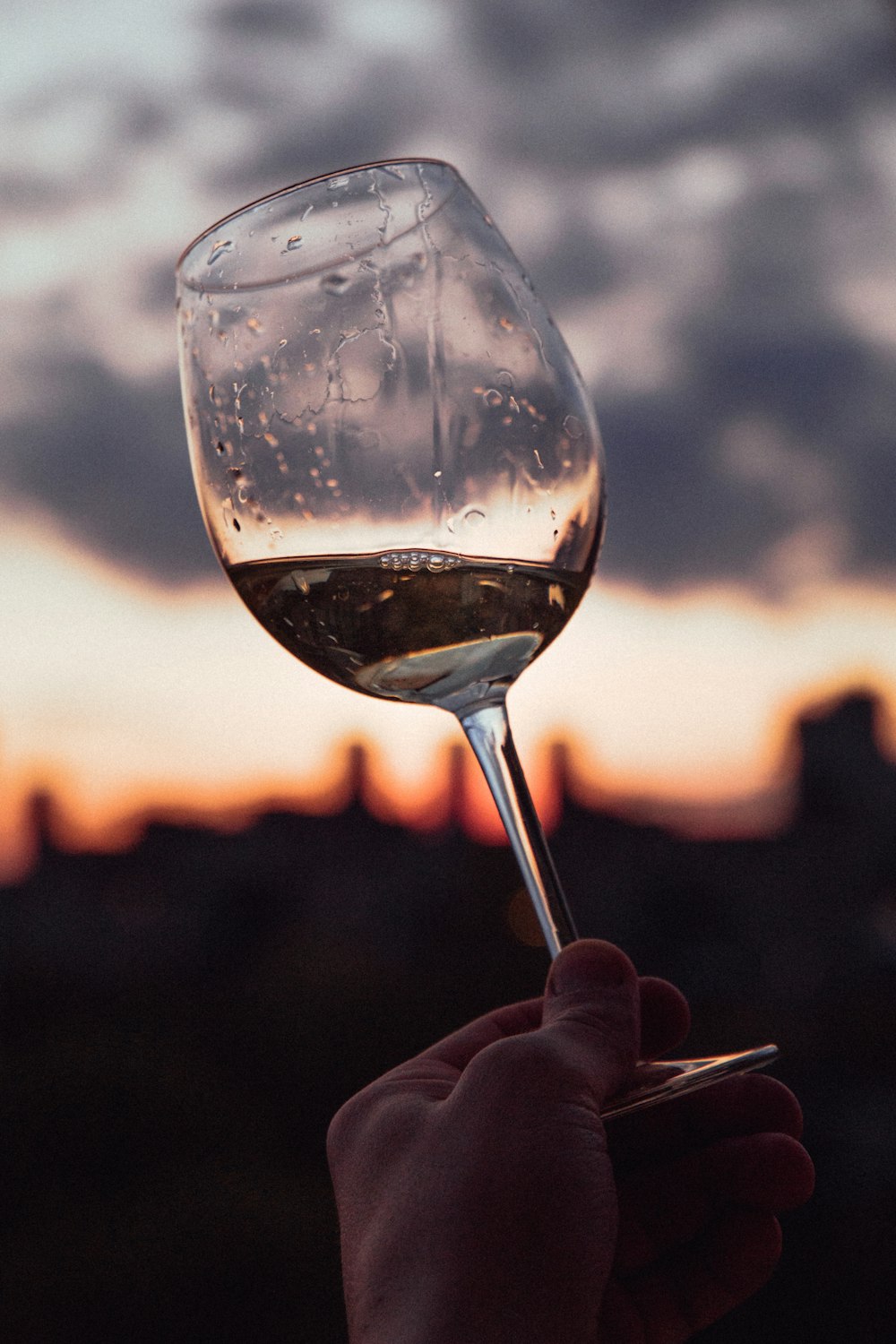 person holding clear wine glass