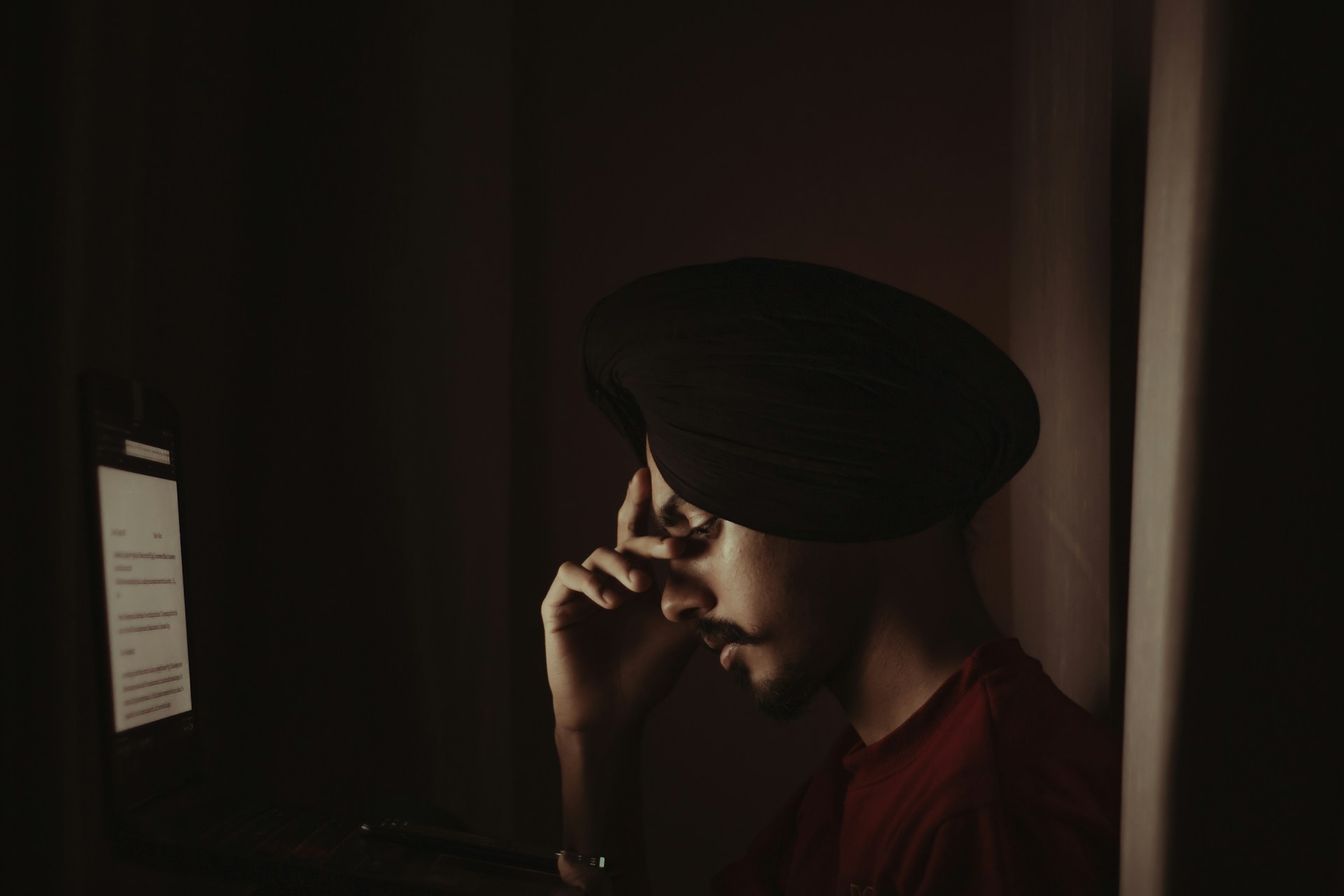 man in black knit cap and red crew neck shirt