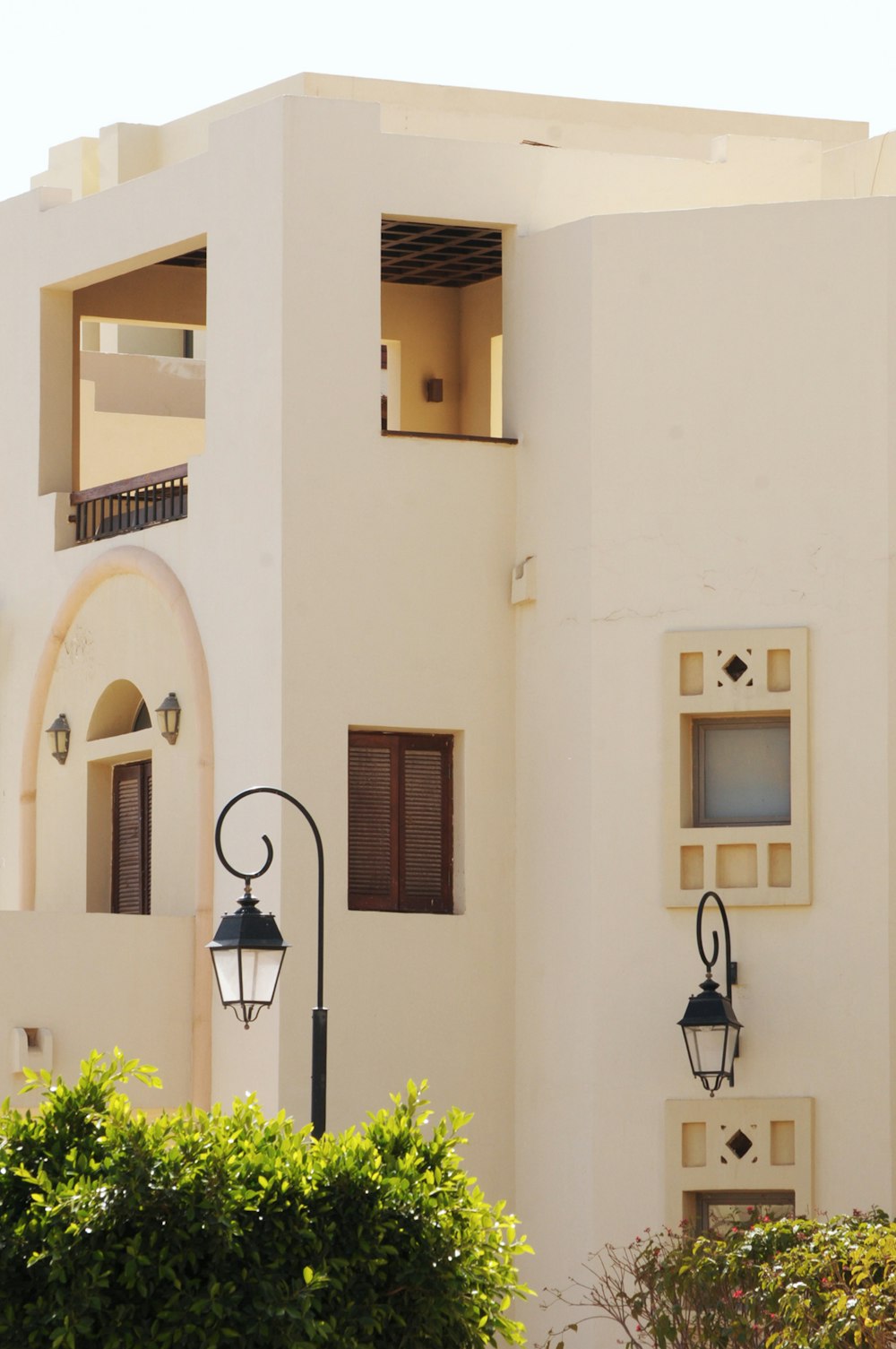 black sconce lamp on white concrete building