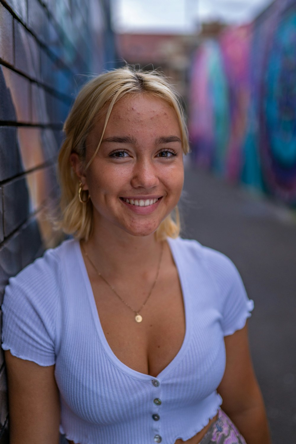 woman in white v neck shirt smiling