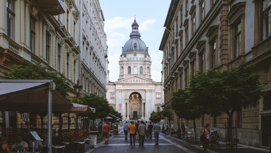 people walking on street near white concrete building during daytime in St. Stephen's Basilica Hungary