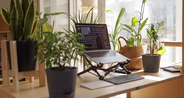 black laptop computer on brown wooden table