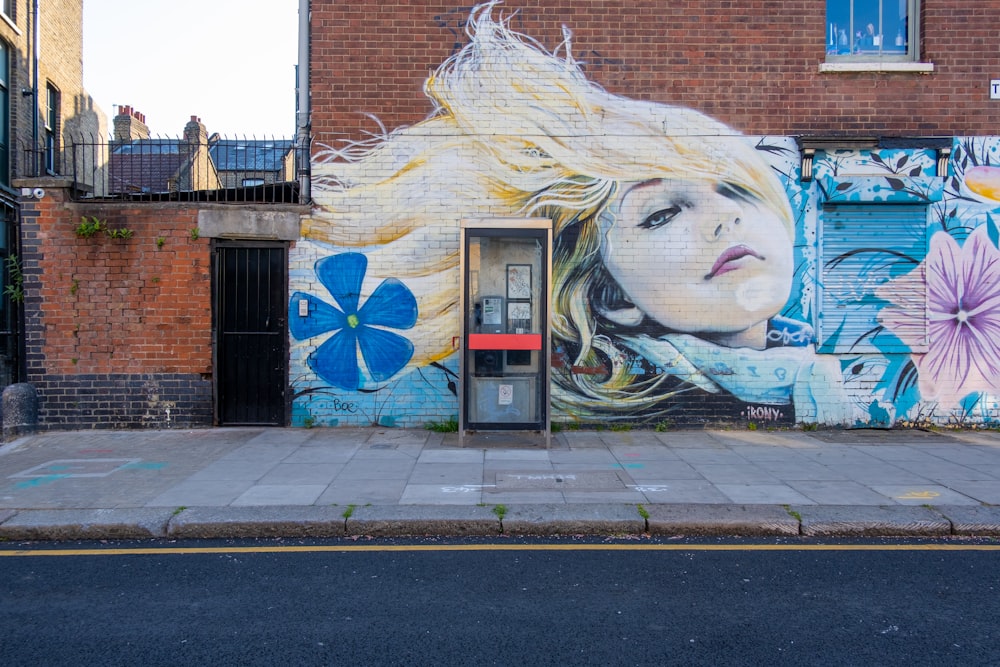 womans face graffiti on wall