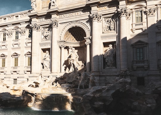 gray concrete building with water fountain in Trevi Fountain Italy