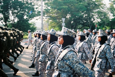 soldiers in black and white uniform standing on gray concrete road during daytime