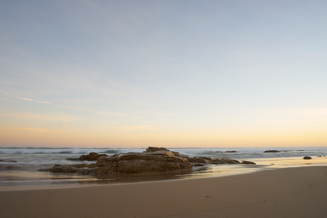 brown rock formation on sea shore during daytime