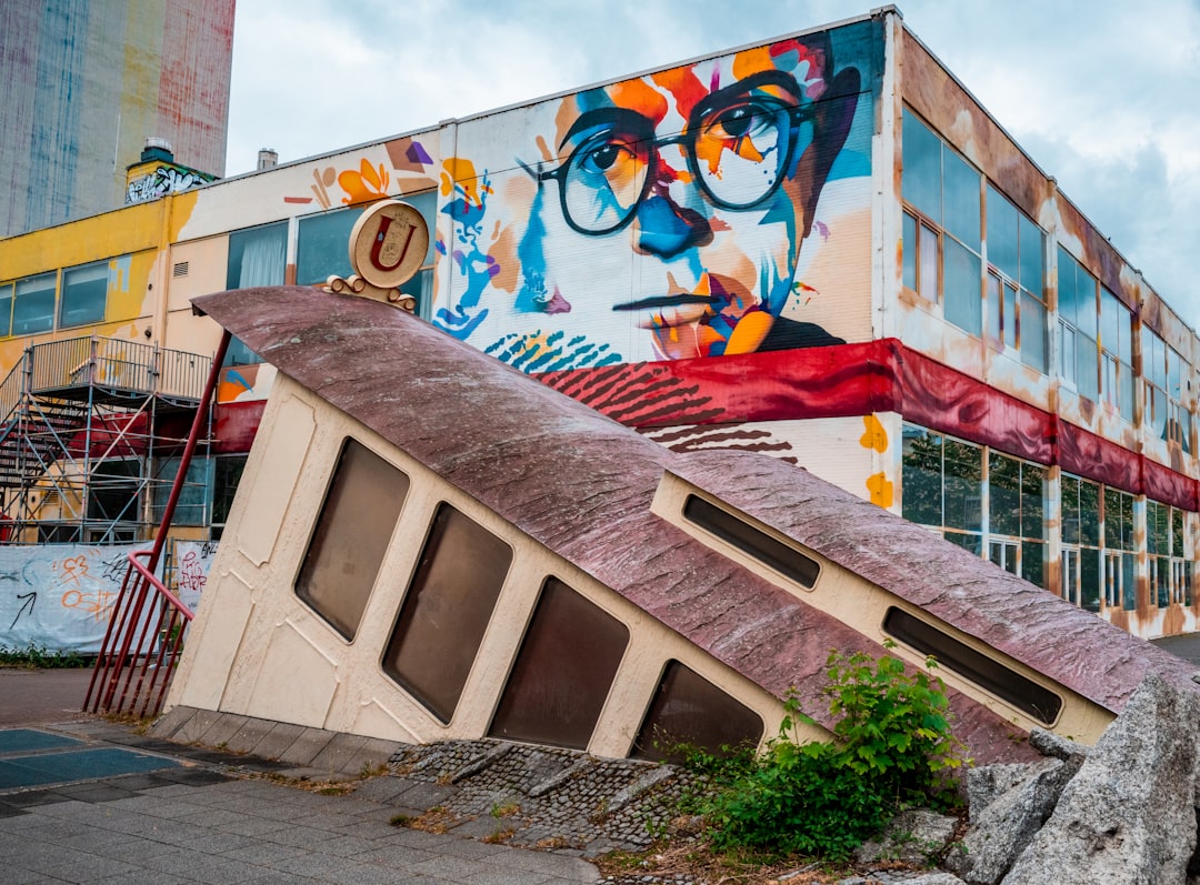 white concrete building with red blue and yellow wall art