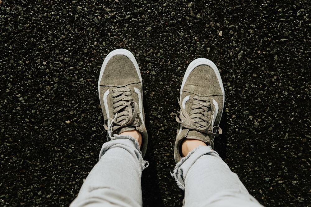 person in gray pants wearing brown and white sneakers