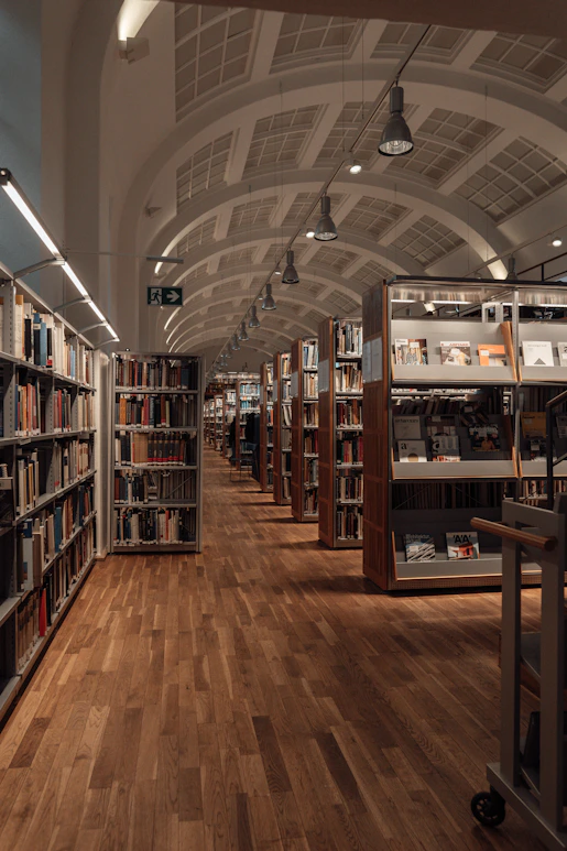 brown wooden book shelves in library
