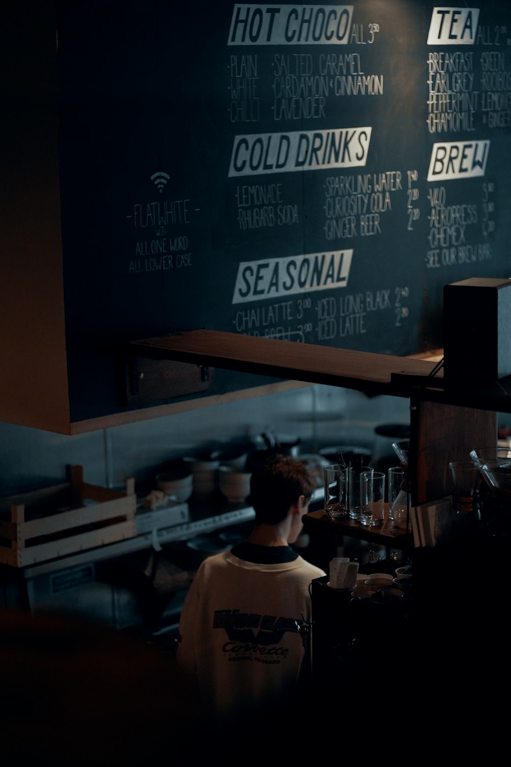 a man standing in front of a menu in a restaurant