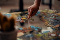 person holding jigsaw puzzle piece