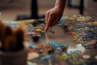 person holding jigsaw puzzle piece