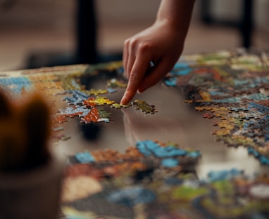 person holding jigsaw puzzle piece