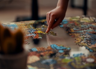 person holding jigsaw puzzle piece