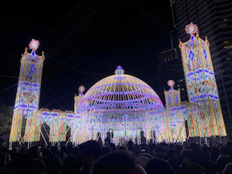 A large 25-meter dome glowing at night during a vibrant festival with spectacular light and sound shows.