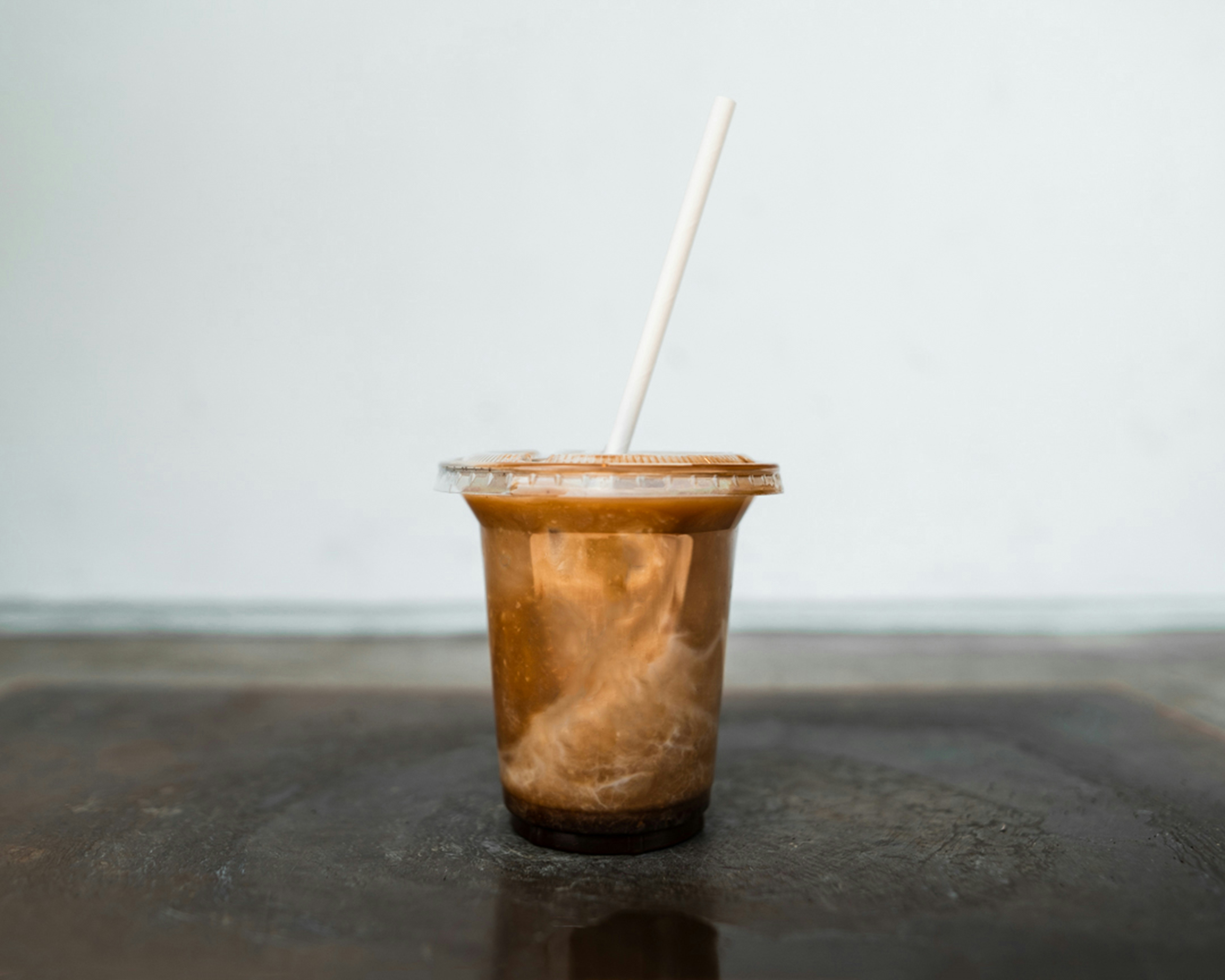 brown and white plastic cup