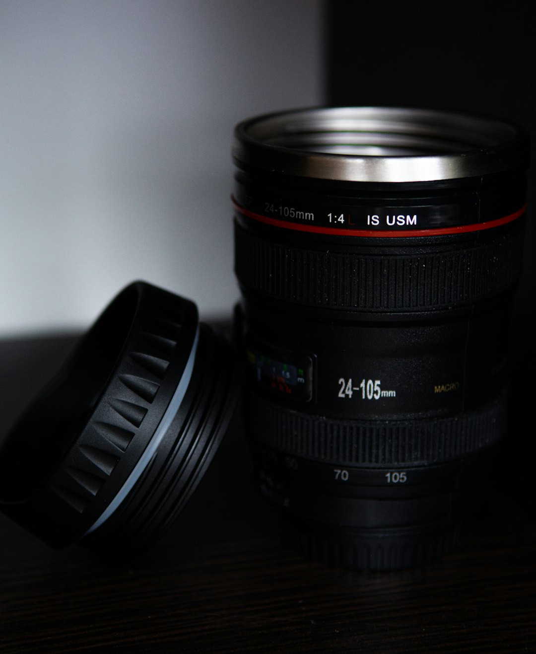 black camera lens on brown wooden table