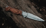brown handle silver knife on brown wooden table