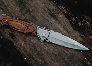 brown handle silver knife on brown wooden table