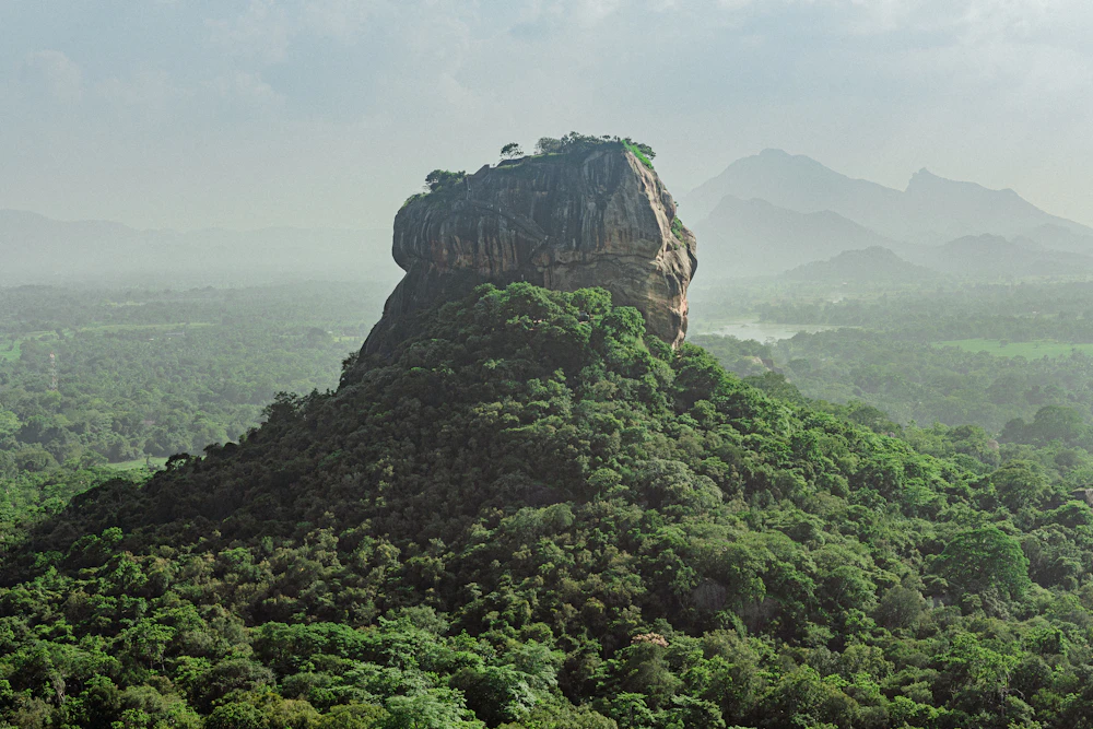 Sigiriya Lion Rock Fortress rising dramatically above surrounding green jungles