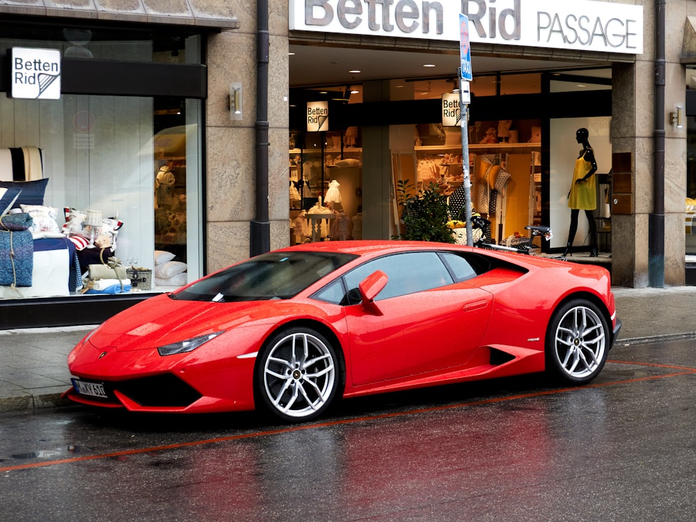 red ferrari 458 italia parked near brown building