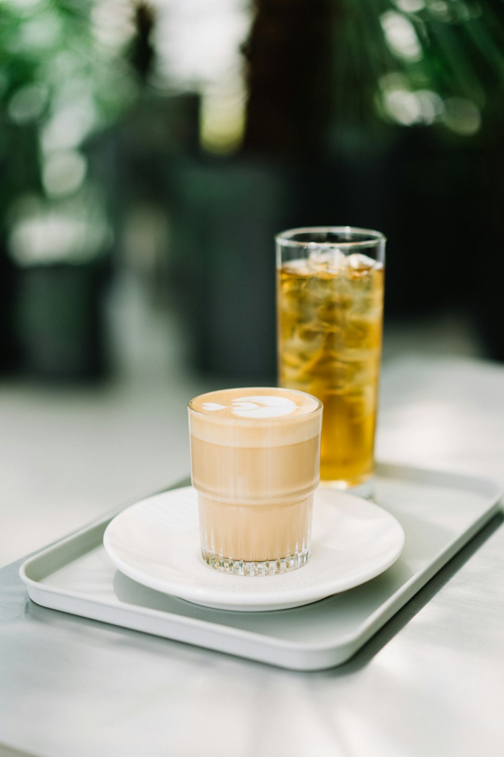 clear drinking glass on white ceramic plate