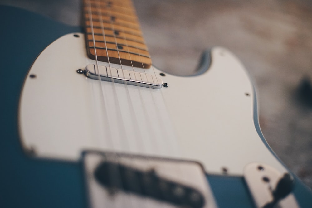 white and blue stratocaster electric guitar