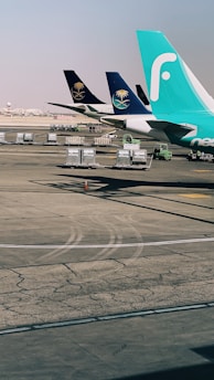 A fleet of cargo planes lined up on the tarmac ready for departure.