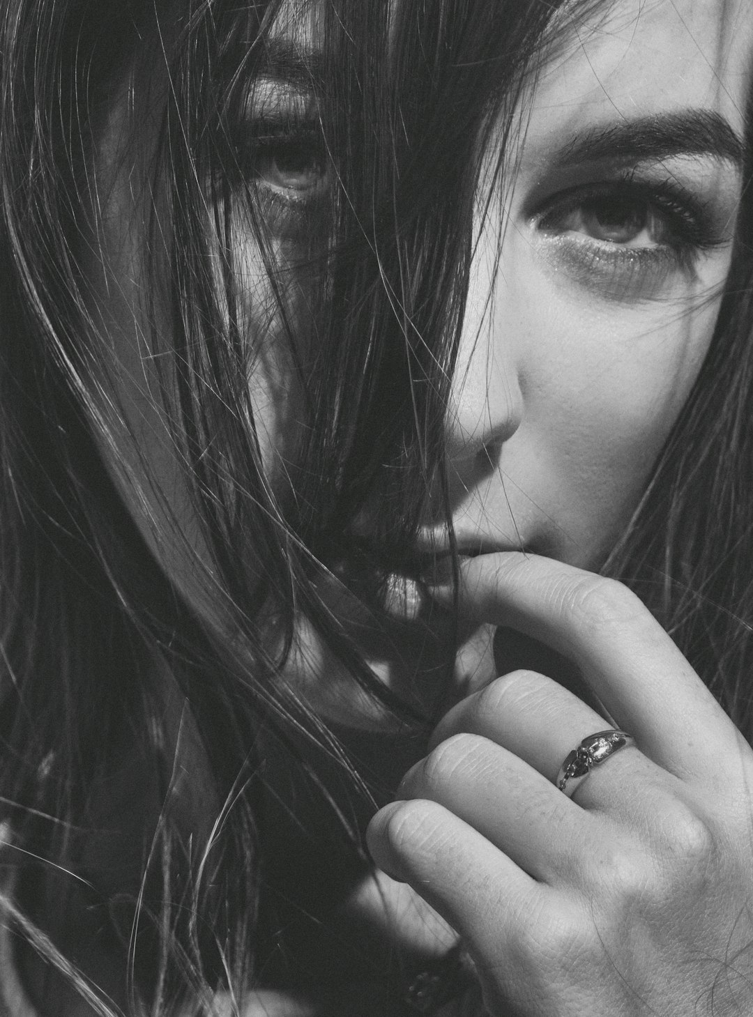 grayscale photo of woman wearing ring